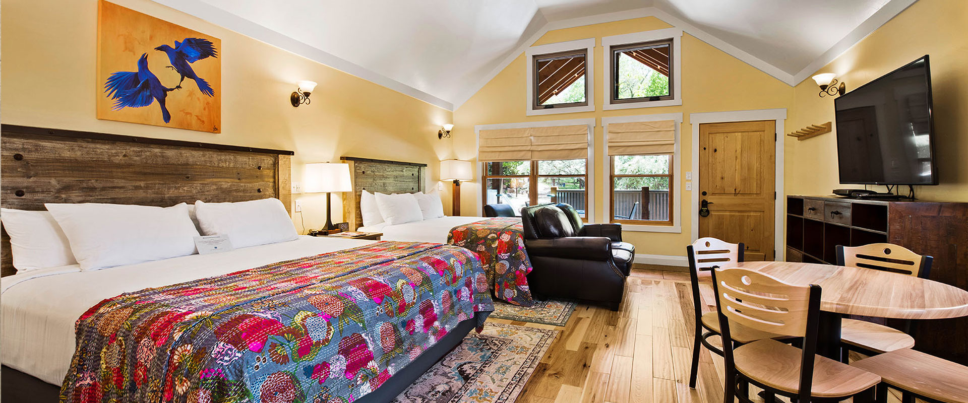 Unit #18 at Moab Springs Ranch features a children's room with a beige wood bunk bed tucked in with multi-colored covers and a turquoise blue shelf stocked with extra bed linen.