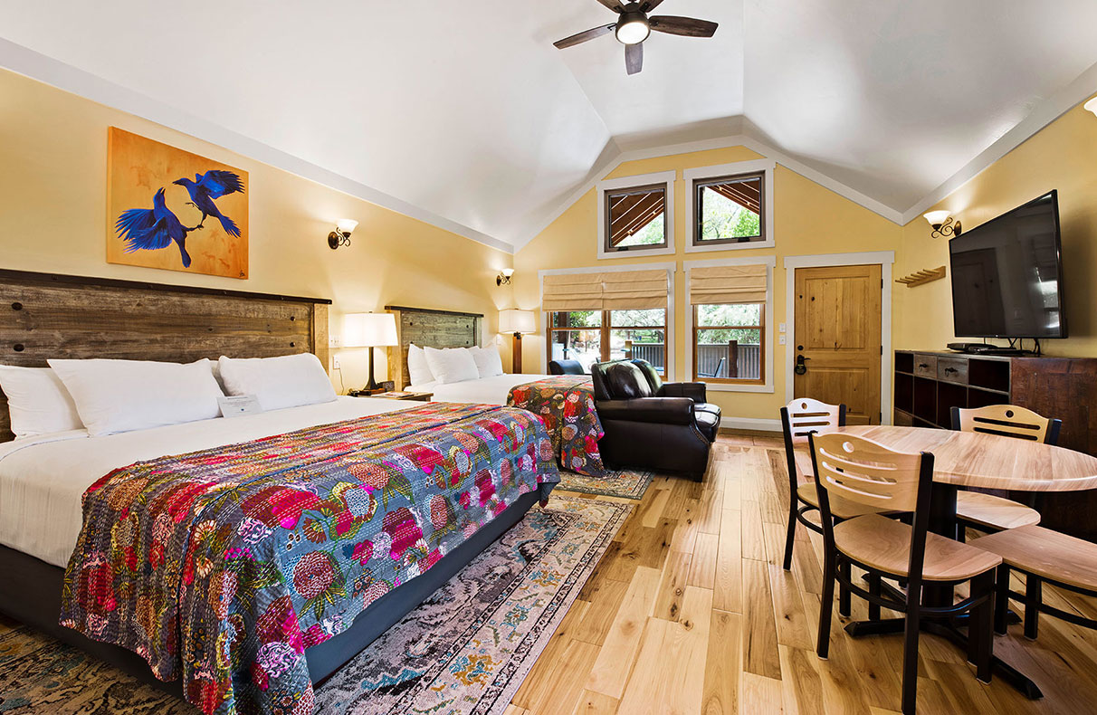Unit #18 at Moab Springs Ranch features a children's room with a beige wood bunk bed tucked in with multi-colored covers and a turquoise blue shelf stocked with extra bed linen.
